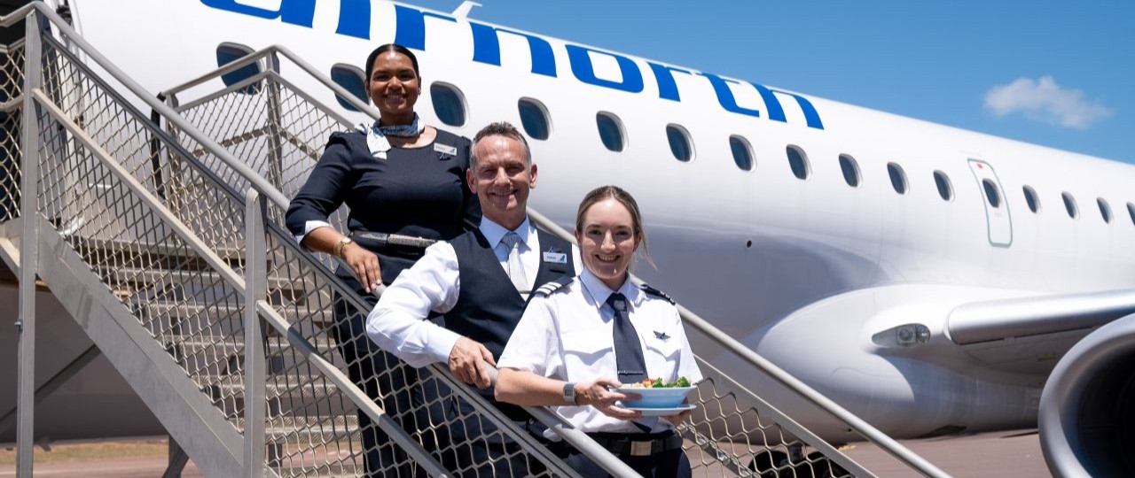 airnorth staff with laksa dish outside aircraft